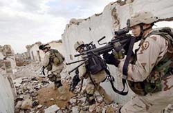US Army soldiers search for insurgents suspected of planting a roadside bomb
