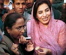 A supporter of the Pakistan Peoples Party gives sweets to Azra, sister of Asif Ali Zardari, husband of Pakistans former Prime Minister Benazir Bhutto, after a Pakistani court decided to grant bail to Zardari in Islamabad on Monday. 