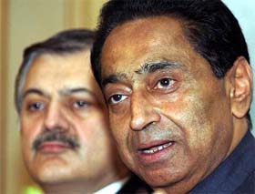 Indian Commerce and Industries Minister Kamal Nath speaks with his Pakistani counterpart Humayun Akhtar Khan during a press conference in Islamabad