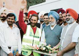 Senior Congress leader Jagpal Singh Khangura and Chief Parliamentry Secretary Milkiat Singh Birmi receive 68-year-old Balwant Singh Grewal
