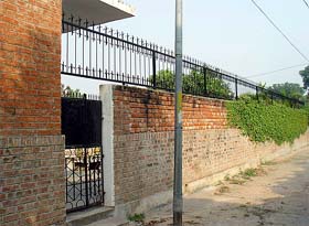 An unusual height of the wall towards service lane and an alleged illegal opening of Beant Kaurs house in Sector 3 in Chandigarh