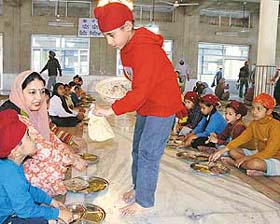 A boy distributes langar at the Sector 19 gurdwara in Chandigarh
