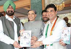 Mr Pawan Kumar Bansal, local MP, releases the party manifesto for the coming MC election. Party candidate Mr Harmohinder Singh Lucky and Mr Jagmohan Singh Kang are also seen in the picture in Chandigarh