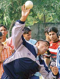 A student throws shot put during the annual sports meet of Government College, Panchkula