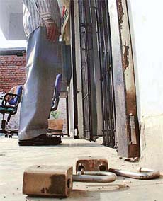 Broken locks lie at the entrance of the State Bank of Patiala, Ramgarh branch, near Panchkula