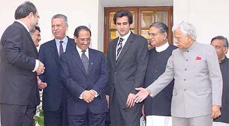 Suited Pakistani ministers huddle together as Indias Foreign Minister Natwar Singh, Petroleum Minister Mani Shankar Aiyar and National Security Adviser J. N. Dikshit look on at Hyderabad House