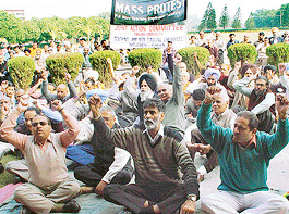 Teaching and non-teaching employees of Panjab University hold a rally outside Administrative Block on campus in Chandigarh, on Thursday.