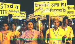 Protesters carry placards that list challenges before farmers