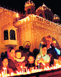 From darkness to light: Devotees light candles on the celebration of Guru Nanak Devs  birthday at the Sector 34 gurdwara in Chandigarh on Friday.