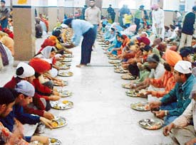 Devotees partake of langar at a gurdwara in Model Town Extension, Ludhiana, on the occasion of Gurpurab on Friday