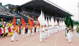 Girls participate in marchpast before the inauguration of the Punjab Schools Inter District Athletics Meet at Guru Nanak Stadium