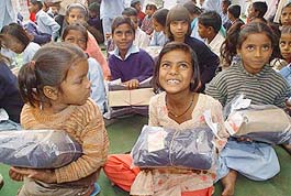 Children of Piya Sharma Street Children School are all smiles after receiving sweaters and shoes.