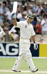 Australian batsman Justin Langer raises his bat after reaching his double century on the second day of the second Test against New Zealand in Adelaide