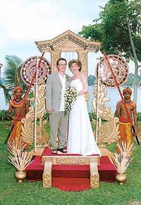 A British couple stands on the Poruwa, the sacred wedding platform