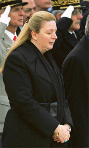 Suha Arafat waits while Yasser Arafats coffin is loaded on to a plane
