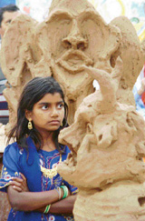 A girl admires sculptures at the Senior Citizens Camp on the concluding day of Chandigarh Carnival at Leisure Valley, Sector 10, Chandigarh, on Sunday.