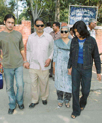 Shiv Kumar, an 88-year-old voter of Sector 20, being led to a polling booth during byelection to Ward No. 11 in Chandigarh on Sunday. 