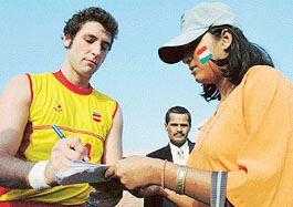 A Spanish player gives an autograph to an Indian supporter after the India-Spain Test match 