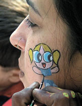 A girl with a tatoo on her cheek during a kids party to celebrate the 9th anniversary of Cartoon Network at India Habitat Centre 