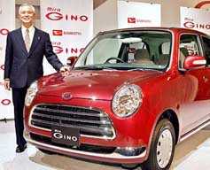 President of Japanese carmaker Daihatsu Motor Takaya Yamada displays the new mini car, Mira Gino, equipped with a 660cc ultra low-emission engine and a classically designed body at a Tokyo hotel 
