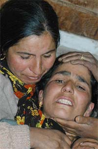 Relatives of Farooq Ahmed, who was killed in firing by the security forces, grieve over his death at his home at Hashru village, 35 km from Srinagar
