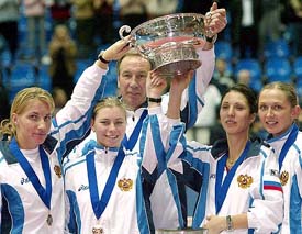 Russian tennis players from left, Svetlana Kuznetsova, Vera Zvonareva, team coach Shamil Tarpishev, Anastasia Myskina, and Elena Likhovtseva, hold the Trophy after winning the Fed Cup final match