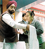 MLA Prahlad Singh Sawhney distributing a rehabilitation package to a Tibetan chhang dealer at Majnu Ka Tila in the Capital on Tuesday.
