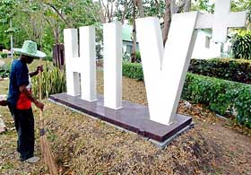An HIV positive sign located at the entrance of a Buddhist temple in Thailand