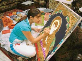 Tanya paints the gold-plated portrait of Guru Nanak