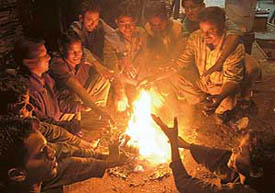 Mechanics of Sector-38 West motor market sit around a bonfire to ward off winter chill in Chandigarh on Wednesday.