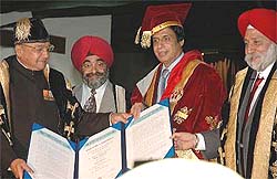 The Punjab Governor, Lieut-Gen S.F. Rodrigues (retd), and the Vice-Chancellor of GNDU, Dr S.P. Singh, confer an honorary degree of Doctor of Literature on Mr Parvaiz Elahi, Chief Minister of Pakistani Punjab, at a special convocation on the university campus in Amritsar on Thursday. 