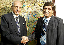 Pakistani Secretary of Railway Zaeen Chaudhry (right) receives his Indian counterpart L.R. Thapar at the Communication Ministry for formal talks in Islamabad on Thursday