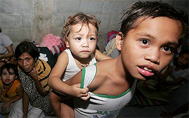 Typhoon evacuees take refuge inside a shelter in Maragongon village, Quezon province, Philippines, on Thursday