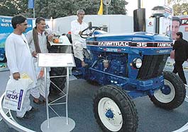 Farmers try out a new model of a tractor at the CII Agro-Tech 2004 in Chandigarh on Friday.