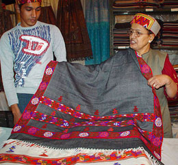 An employee of the HP State Handicrafts and Handloom Corporation Limited shows a Kinnauri to a visitor at the exhibitin-cum-sale in Lajpat Rai Bhavan, Sector 15, Chandigarh, on Friday.