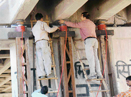 To repair the bridge over the Ghaggar river, employees lift the third span of the bridge with the help of  hydraulic elevators to insert bearings on Friday.