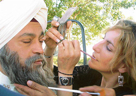 An artist applies make-up for the shooting of a scene of 'A Love Story', in Chandigarh on Friday.