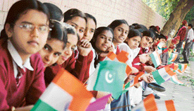 Students line up on the Mall Road waiting for the torch of the Indo-Pak Games-2004 to pass through the area in Ludhiana