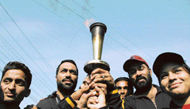 Former international players hold the games torch during its procession in Ludhiana on Friday