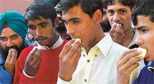 Visitors to the NECC stall at Agrotech 2004 going on at Parade Ground, Chandigarh, rush to get their share in an egg-eating contest on Saturday