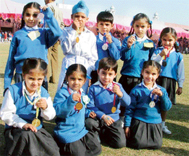 Children show their medals which they won during the 28th annual inter-house athletics meet of Guru Nanak Public School, Sarabha Nagar, Ludhiana