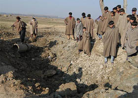 Villagers look at the explosion site at Wachi village, 65 km south of Srinagar