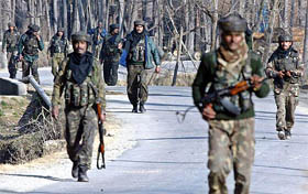 Army men patrol a street after a landmine explosion at Liter, 50 km south of Srinagar