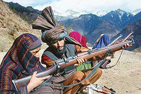 Tahir Hussain Chowdhury, a member of the Village Defence Committee, gives arms training to a village woman to fight militants in Kulali village, 260 km northwest of Jammu