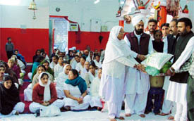 Mr Sushil Prashar, president of the Punjab Nishkam Seva Dal, distributes ration among needy persons in Ludhiana on Sunday