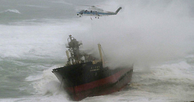 A Japanese Coast Guard helicopter tries to rescue crewmen from a stranded cement carrier off the coast of Aomori