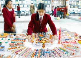 DAV Public School students display candles made by them, in Ludhiana