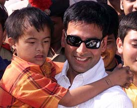Film star Akshay Kumar carries a mentally retarded child during the closing ceremony of the five-day Asia Pacific International Cricket Tournament in Ahmedabad on Monday. 