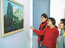 Visitors admire one of the paintings by Ravinder Sharma on display at the Fine Arts Gallery, Panjab University, Chandigarh, on Tuesday. 