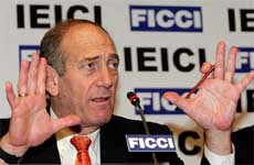 Israels Deputy Prime Minister Ehud Olmert gestures during a business seminar in New Delhi on Wednesday. 